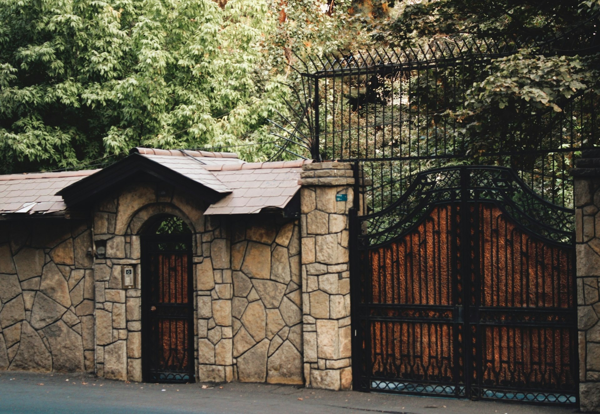 a stone building with a gate and a gated entrance
